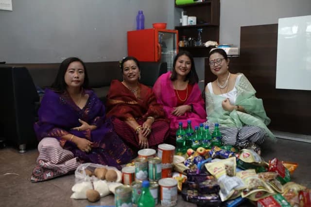 Guests seated with offerings at a gym celebration